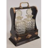 A Victorian coromandel electroplated mounted tantalus housing two clear hobnail cut glass square