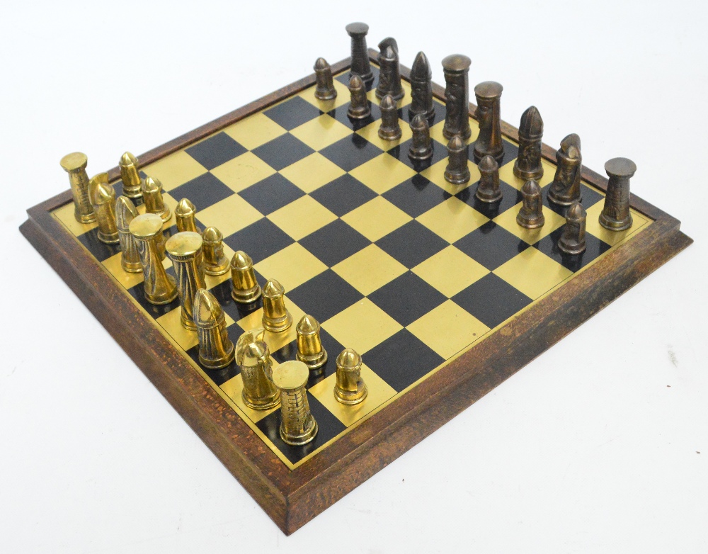 A set of brass and bronzed chess pieces modelled as Norse men,