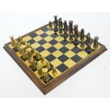 A set of brass and bronzed chess pieces modelled as Norse men,