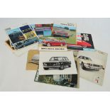 A group of 1960s car catalogues including Saab 96, MG, Triumph Stag, Jeep CJ, Morris 1800, etc.