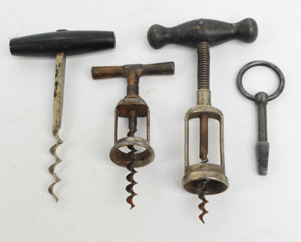 A small collection of corkscrews including two with wooden handles and one with a ball bearing