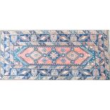 A Turkish hand knotted navy blue and red rectangular carpet with geometrical motif to the centre