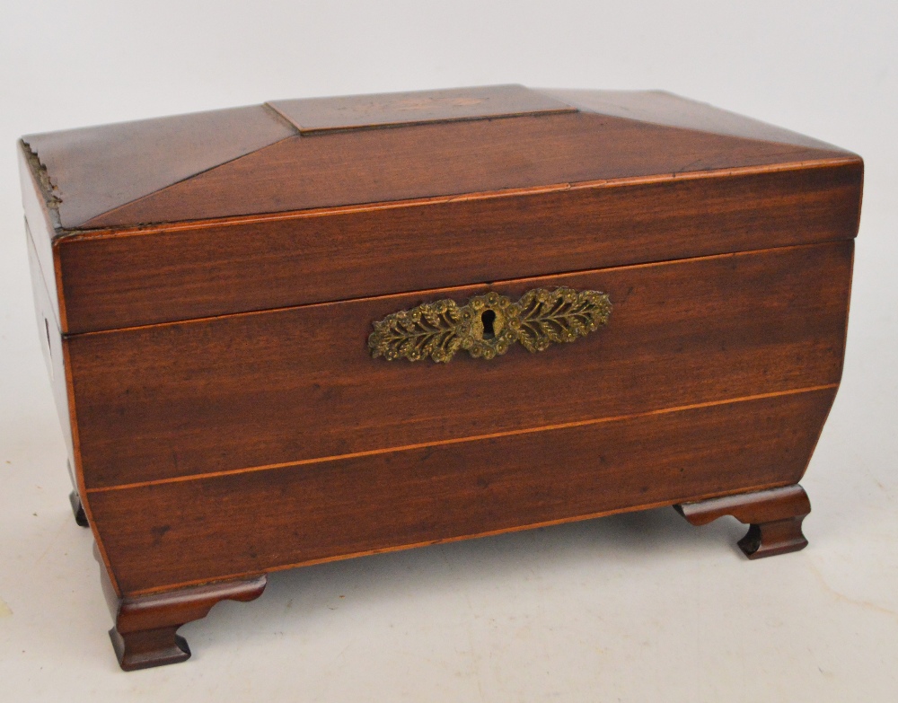 An early 19th century mahogany sarcophagus shaped tea caddy with inlay of flowers to the top and