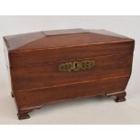 An early 19th century mahogany sarcophagus shaped tea caddy with inlay of flowers to the top and