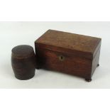 A 19th century oak tea caddy of plain circular form with two division lidded interior on turned bun