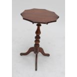 An oak tripod table with shaped circular top on ring turned column with cabriole feet,