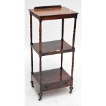 A rosewood rectangular two tier whatnot with ring turned columns and single drawer, on castors,