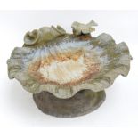 A reproduction lead bird bath in the form of a shell, surmounted by a bird.