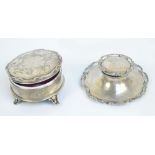 An Edward VII hallmarked silver loaded circular inkwell with ceramic liner,