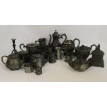 A group of pewter ware comprising teapots and mugs,