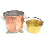 A copper hammered log bin with brass handles and four paw feet, height 31cm,