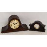 A 1920s oak Napoleon hat eight day chiming mantel clock, the circular dial set with Arabic numerals,