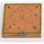 A square sectioned enamel decorated compact, the hinged lid decorated with birds amongst scrolls,