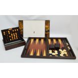 A 20th century folding backgammon board with dice, counters and throwing cups,