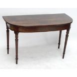 A late George III mahogany D-end table with fluted rim raised on turned legs to peg feet, height 72.