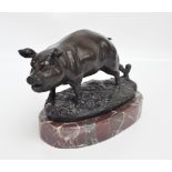 A spelter figure of a pig with one leg tied to a peg, on oval base and pink marble plinth,