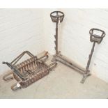 A wrought iron fire grate and a pair of andirons.