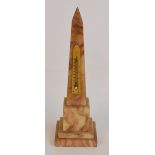 An early 20th century thermometer, the ivorine plaque applied to an alabaster obelisk, height 27cm.