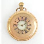 A late 19th/early 20th century gold plated cased crown wind half hunter pocket watch,
