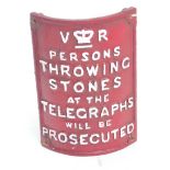 A Victoria Regina painted cast iron curved sign inscribed "Persons throwing stones at the