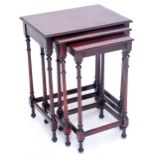 A mahogany nest of three rectangular tables on ring turned supports, the largest top 40.5 x 32.5cm.