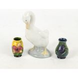 Two miniature Moorcroft vases including a baluster "Anemone" pattern decorated example on green