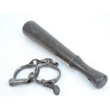 A pair of metal screw key handcuffs stamped "Froggatt 38" and a wooden truncheon with a Home Guard