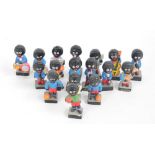 A collection of seventeen ceramic Golly jazz band figures, also including three footballers.