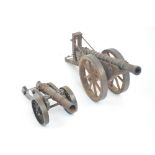 WITHDRAWN An early to mid 20th century model of a cannon with wooden gun carriage and wheels,