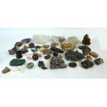 A collection of various predominantly rough stones including coloured quartz and marble,