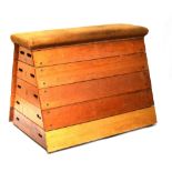 A vintage stacking five section vaulting box with padded top, numbered ends, and angled sides.