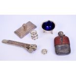 A George V hallmarked silver mounted small glass hip flask with leather upper side,