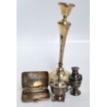 A George V hallmarked silver candlestick with bell shaped sconce and tapering stem above spreading