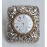 A Victorian hallmarked silver fronted eight day travelling clock of rounded rectangular form
