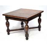 An early 20th century oak dining room suite comprising drawleaf table,