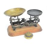 A set of late 19th century cast iron scales with painted decoration and large brass pan set on a