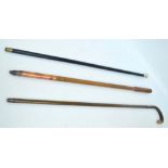 A group of six various walking sticks including a white metal handled ebonised and bamboo examples