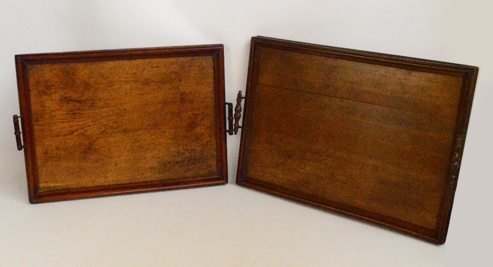 Two similar Edwardian oak twin handled trays of rectangular form, the larger 58 x 41.5cm (2).