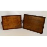 Two similar Edwardian oak twin handled trays of rectangular form, the larger 58 x 41.5cm (2).