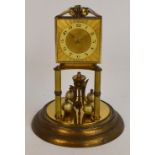 A brass anniversary clock, the rectangular face with circular chapter ring set with Arabic numerals,