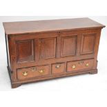 A George III oak mule chest, the hinged lid above four panelled front and three drawers,