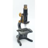 A gilt and painted metal monocular microscope inscribed "C Baker of London" and "Kima",