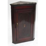 A Georgian mahogany flat fronted wall hanging corner cupboard,