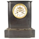 A late 19th century French black slate mantel clock with white enamel dial set with Roman numerals