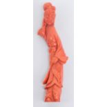 A Chinese carved coral figure of a young woman holding a feather in her left hand, length 14cm,