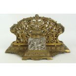 A 19th century brass two division letter rack with pierced foliate scroll decoration,