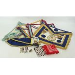 A small group of Masonic regalia comprising four aprons, one from the East Lancashire Lodge,