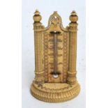 A 19th century finely carved ivory thermometer flanked by two decorative columns on semi-circular