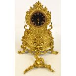 A decorative French brass mantel clock with Roman numerals to the black painted dial with eight day