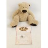 A boxed Hallmark Wellington teddy bear with beige distressed fur and beany bottom, height 32cm,